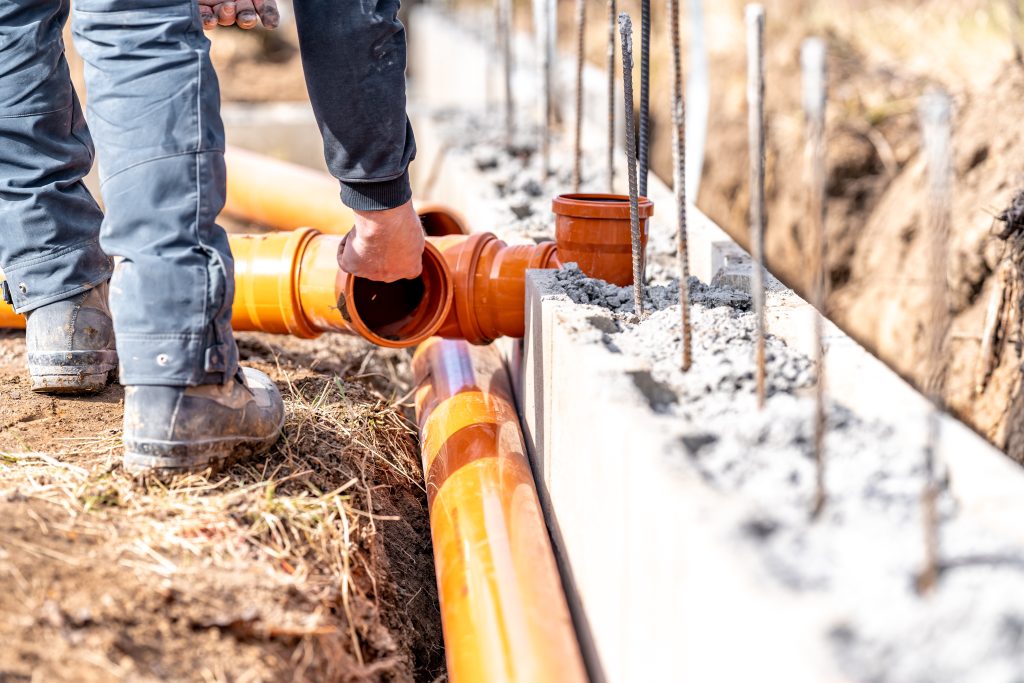 Installation Of A Sewage Plastic Pipe During The Construction